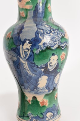 Lot 260 - Near pair of Chinese crackle glaze vases, decorated in underglaze blue with figures on a green and iron red ground, Kangxi marks but later, 18cm and 19cm high