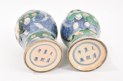 Lot 260 - Near pair of Chinese crackle glaze vases, decorated in underglaze blue with figures on a green and iron red ground, Kangxi marks but later, 18cm and 19cm high