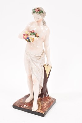 Lot 67 - Faience figure of Venus, standing holding flowers