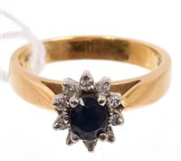 Lot 407 - Sapphire and diamond cluster ring with an oval...