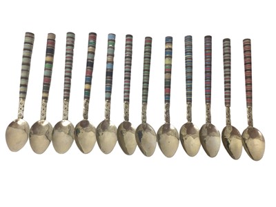 Lot 363 - Set of twelve white metal teaspoons, with decorative coloured handles