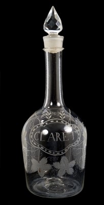 Lot 303 - A rare George III Irish glass magnum decanter, engraved 'Claret' within a faux bottle label, with foliage, 40cm high