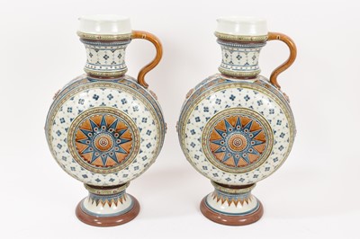 Lot 309 - Pair of Mettlach salt glazed stoneware ewers, impressed marks, 35.5cm high