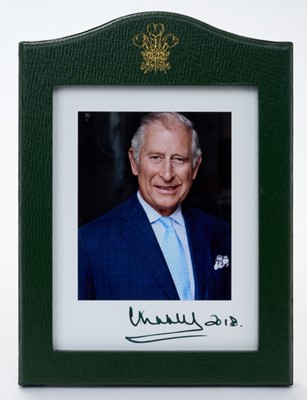 Lot 150 - H.R.H. Prince Charles The Prince of Wales ( now H.M.King Charles III) fine signed presentation portrait photograph of the smiling prince signed in ink 'Charles 2018' in original green Morocco leath...