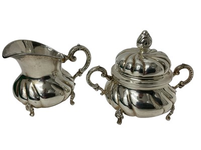 Lot 1652 - Continental rococo style sterling silver sugar bowl and cover and en-suite milk jug