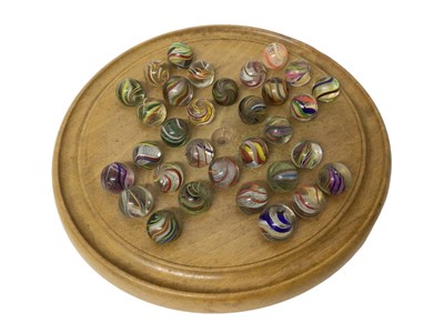 Lot 855 - Collection of 32 antique German latticino marbles with vintage solitaire board