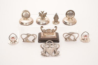 Lot 428 - A group of silver menu holders to include a pair of Army Service Corp regimental silver menu holders, another with Bishop's mitre, a pair of Edwardian silver menu holders with enamel Cardinal's hat...