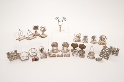 Lot 429 - Collection of antique silver menu holders to include two sets of four, six pairs, and others, plus one pair of plated menu holders