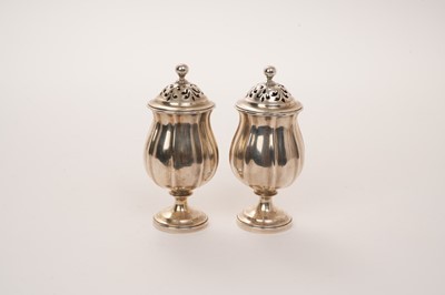 Lot 446 - Pair of George IV silver pepperettes/pounce pots of tulip head form on pedestal foot, London 1828. Height 9.5cm.