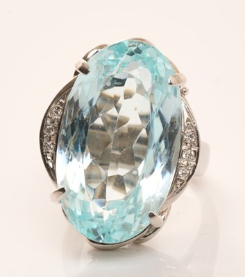 Lot 584 - Aquamarine and diamond cocktail ring with a large oval mixed cut aquamarine in platinum setting with diamond set shoulders