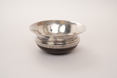 Lot 453 - Arts & Crafts silver and turned wooden maizer, the hammered silver bowl with turned wooden base, by A E Jones, Birmingham 1919, 14cm diameter.