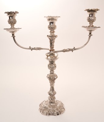 Lot 459 - George IV silver Rococo-revival candlestick 26cm high, date letter indistinguishable, together with a silver plated three-branch candelarbrum fitting, 48cm.