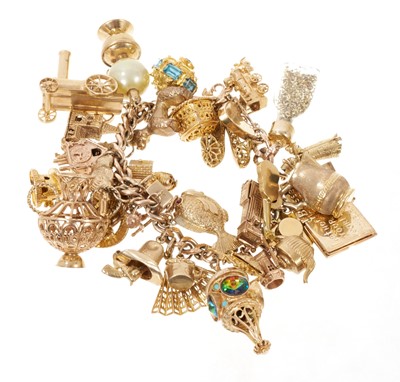 Lot 445 - Gold charm bracelet with an extensive collection of 9ct gold charms