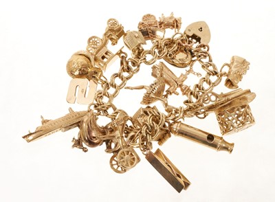 Lot 446 - Gold charm bracelet with a collection of 9ct gold charms