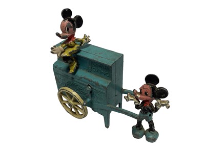 Lot 1857 - Walt Disney Interest - A late 1940s Salco (Saalheimer & Co.) Mickey Mouse and Minnie Mouse barrel organ set, comprising a blue painted lead barrel organ on spoked cream wheels, with a winding hand...