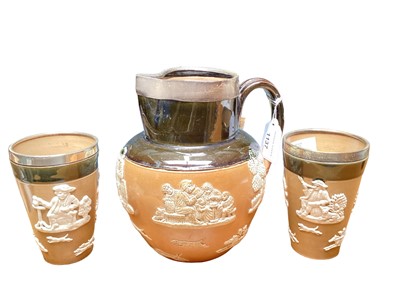 Lot 1137 - Late Victorian Royal Doulton salt glazed stoneware beer/ale jug and pair of tumblers with applied hunting, drinking and harvest scenes, with silver rims, hallmarked London 1904