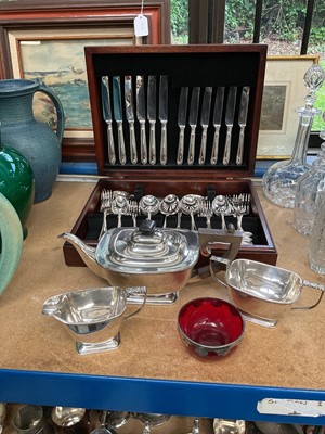 Lot 54 - Canteen of EPNS cutlery, bead pattern, 6 place settings and EPNS 3 piece teaset, 6 EPNS teaspoons, Kings pattern, 6 butter knives, small red glass bowl with silver/EPNS ? patterned rim