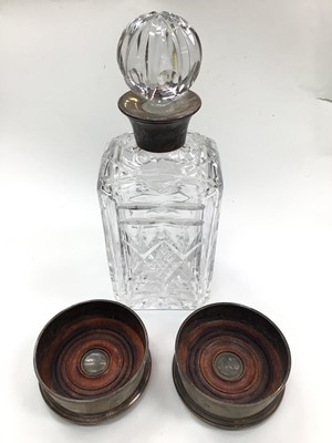 Lot 1017 - Silver collared glass decanter together with a pair of silver turned wood wine coasters