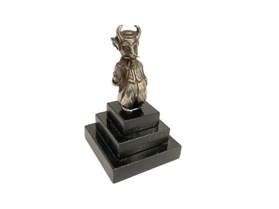 Lot 46 - “Lucifer Golfing Society" plated car mascot depicting a devil in smoking a pipe, later mounted onto a stepped marble base, the figure 7.6cm in height (excluding base).