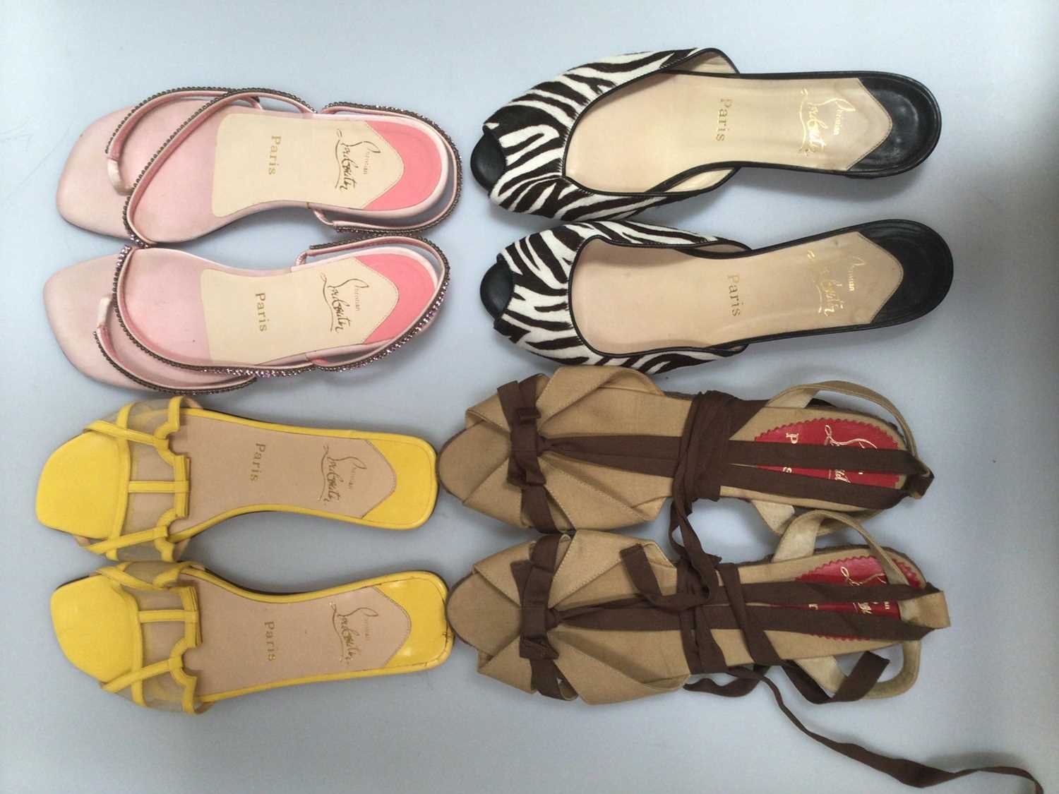 Lot 2097 - Seven pairs of Christian Louboutin sandals including a pair of unused black strap flat sandals, four other pairs of flats and two pairs of heels, sizes 39½- 40