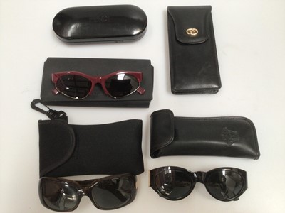 Lot 2101 - Pair of Versace black sunglasses with gilt Medusa design, MOD617/B, in Versace leather case, two other sunglasses, Gucci leather pouch and an empty Fendi sunglasses case