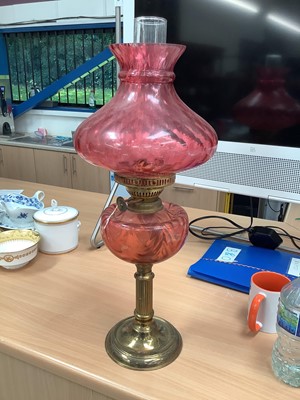 Lot 792 - Cranberry glass and brass oil lamp with shade