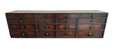 Lot 1261 - Early 19th century fruitwood nest of sixteen graduated drawers, 94cm wide x 20cm deep x 26cm high