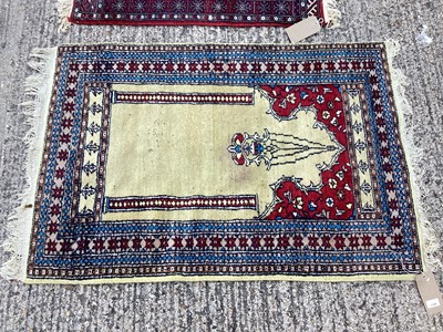 Lot 1330 - Two Eastern rugs together with a large roll of velvet fabric (3)