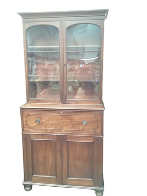 Lot 1278 - 19th century mahogany two height secretaire bookcase, the glazed upper section above a fitted drawer and twin panelled doors below, on bun feet