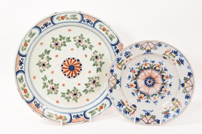 Lot 133 - Two 18th century tin glazed dishes, polychrome painted, the smaller Dutch and the larger probably French, 23.5cm and 31cm diameter