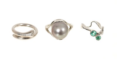 Lot 435 - Three contemporary platinum and gem-set dress rings