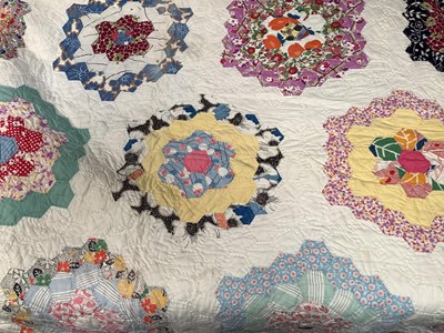 Lot 2118 - Two mid century American patchwork quilts, 'Flower Garden' design, 180 cms x 220 cms approximately and a nine patch diamond design, both mainly handstitched with some machine stitching. 200 cms...