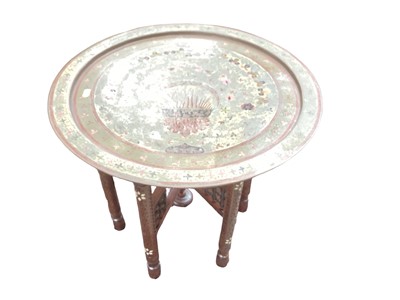 Lot 1224 - Eastern folding occasional table with brass top, together with a mahogany toilet mirror (2)