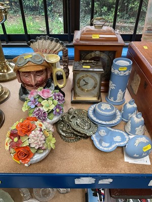 Lot 256 - Two mantel clocks, Royal Doulton Veteran Motorist D6633, Royal Doulton North American Indian HN6611, two Royal Doulton porcelain floral arrangements, collection of Wedgwood blue Jasper ware, and...