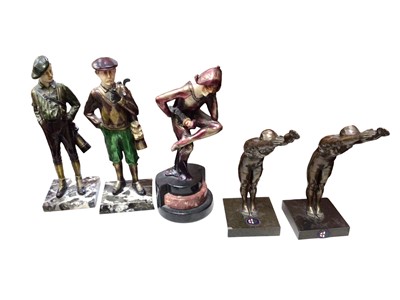 Lot 321 - Two resin golf figures and a resin harlequin figure, all signed Pearce and two swimming figure trophies (5)