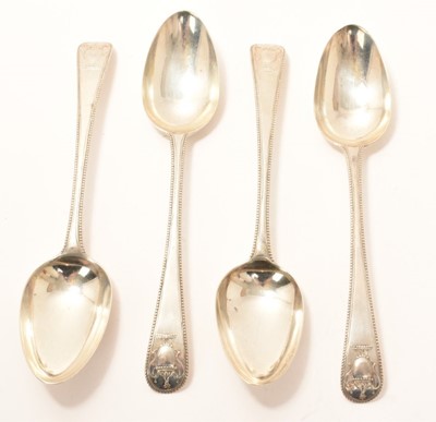 Lot 284 - Set of four George III Bead Edge with Vase pattern serving spoons