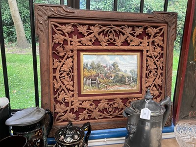 Lot 747 - English Schol, early 20th century, oil on board - View of Winchelsea, in ornate carved wood mount and frame