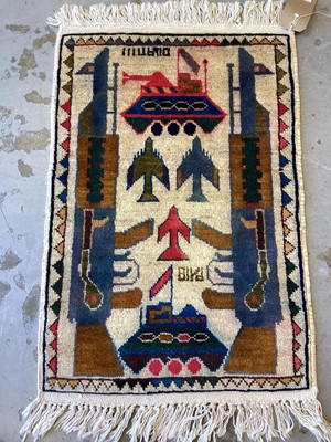 Lot 1332 - Small rug decorated with tanks and guns, 80cm x 53cm