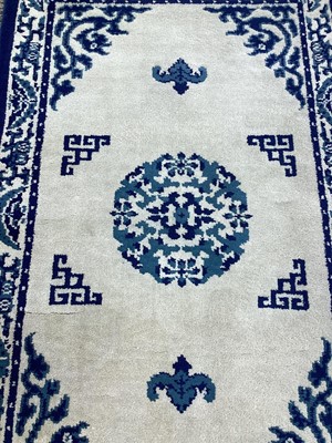 Lot 1507 - Indian Bengali wool pile rug with central medallion on cream and blue ground, 156cm x 54cm