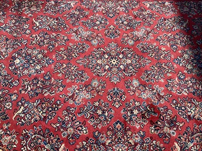 Lot 1338 - Large Eastern rug on red and blue ground, 276cm x 176cm