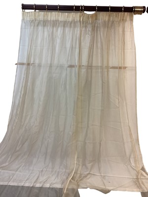 Lot 1427 - Four pairs of pale gold voile curtains. Pair one- top width 165cm, full fabric width 290cm, drop length 260cm. Pair two- top width 133cm, full fabric width 316cm, drop length 325cm. Pair three-...