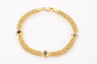 Lot 487 - 18ct gold bracelet with three clusters, each centred with an oval cabochon blue sapphire surrounded by eight brilliant cut diamonds