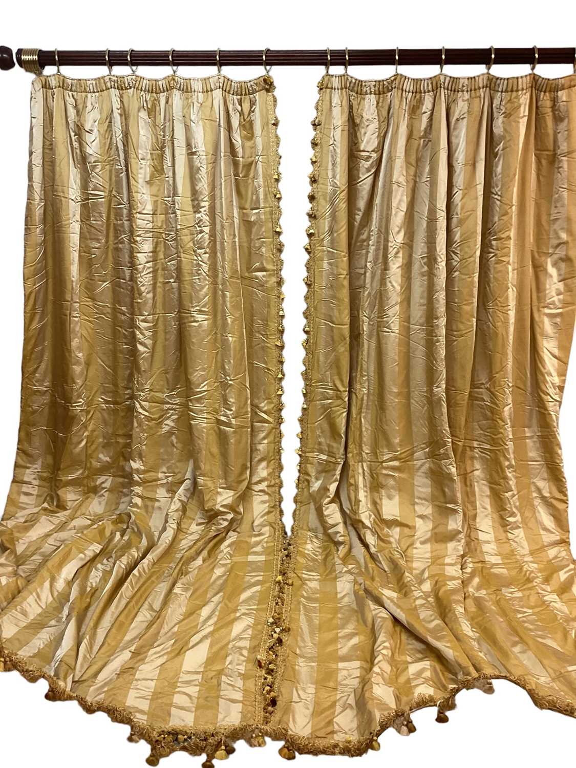 Lot 1429 - Two pairs of Pierre Frey Etad silk and acetate gold striped curtain with tasselled fringe and rope braid decoration with very large pelmet for bay window. Pair one- top width 290cm, full fabric...