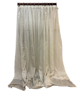 Lot 1433 - Pair of off-white voile curtains gathered at top, top width 183cm, full fabric width 430cm, drop length 268cm.