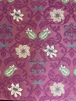 Lot 1449 - Three remnants of fabric rolls, green velour leaf on cream background 130cm in length. Pink silk damask, 92cm in length. Heavy red cotton with green and gold flowers and leafs, 433cm (3)