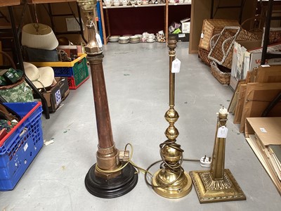 Lot 528 - Unusual copper and brass table lamp constructed from the end of a Merryweather fire hose, together with two further brass lamps (3).