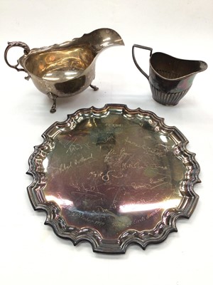 Lot 1054 - Silver card tray with engraved signatures, silver sauce boat and a silver cream jug (3)