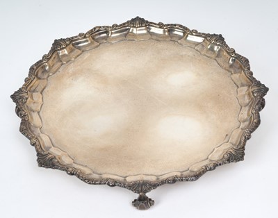 Lot 304 - 1930s silver salver of octagonal form, with scroll and shell border, on four scroll feet