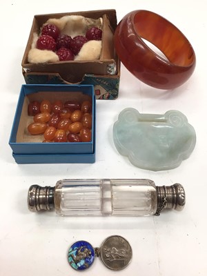 Lot 1070 - Chinese jade/ green hard stone plaque/ pendant, simulated amber beads, other carved beads, bangle, two silver St. Christopher pendants and a white metal mounted double ended glass perfume bottle...