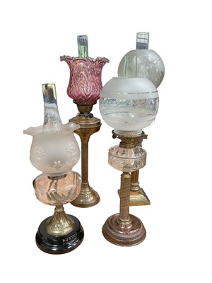 Lot 738 - Four Victorian oil lamps, including one with a cranberry shade